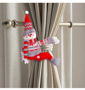 Detail of a plush snowman curtain tieback with a red and grey knitted hat for Christmas