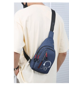Detail showing cartoon character print on blue crossbody chest bag with adjustable strap