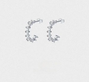 Detail showing S925 sterling silver stamp and baguette-cut cubic zirconia on C-shape earrings