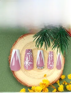 Detailed view of Christmas press-on nails with purple base, white snowflakes and rhinestones
