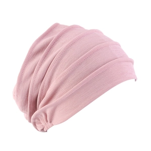 Detail showing the pleated knit texture and soft fabric of the light pink turban hat