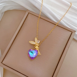 Detail view of heart-shaped multi-color crystal necklace on beige velvet jewelry box