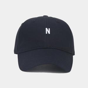 Close-up of premium black cotton baseball cap featuring white 3D letter N embroidery