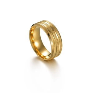 Macro view of gold stainless steel ring with frosted texture and polished edges