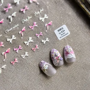 Macro view of 3D embossed bow nail stickers with lace and pearl decorative effects