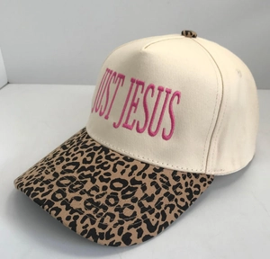 Detailed embroidery of pink JUST JESUS text on off-white canvas baseball cap brim