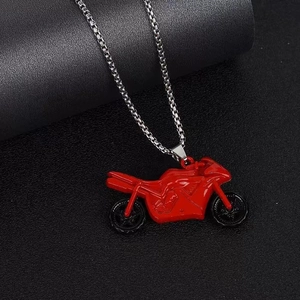 Close-up of a hip hop style necklace featuring a red motorcycle pendant on a silver box chain