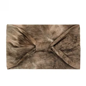 Detail shot of leopard print elastic yoga headband showing textured dark brown fabric knot