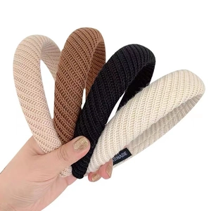 Set of four knitted wide headbands in neutral colors with handmade label detail