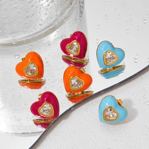 Chic heart-shaped earrings with colorful enamel and inset zircon on a mirror background