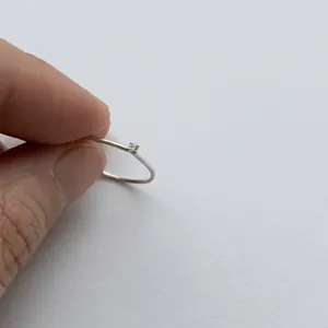 Detailed view of minimalist 925 sterling silver ring with a small sparkling zircon stone