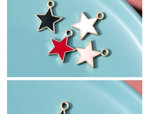 Detail of colorful star pendants in black, white, red, and pink with gold edges