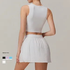 Women's white athletic set featuring a slim fit tank top and high-waisted pleated tennis skirt