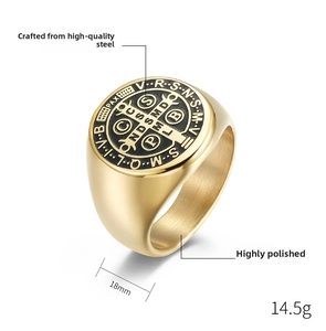 Macro view of gold vintage Saint Benedict cross ring with engraved religious symbols