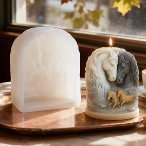 Detail of 3D horse and castle relief candle mold on a tray with warm natural sunlight