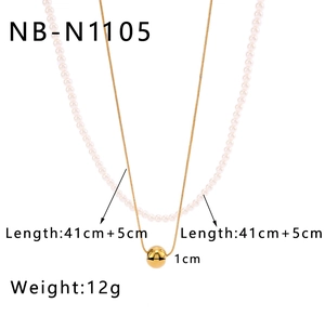 Detailed view showing 1cm gold ball pendant and white pearl layered necklace dimensions