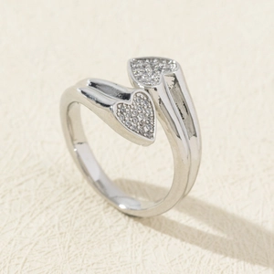 Detail of silver heart-shaped adjustable ring featuring pavé set cubic zirconia stones