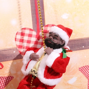 Close-up of black electric climbing Santa Claus figurine on gold bead string