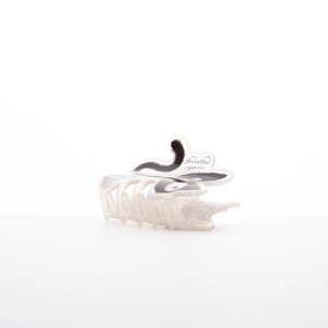 Detail view of pearl white cat hair claw clip with Unidentified Organism pattern