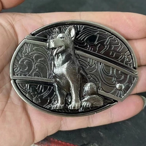 Close-up of a metal belt buckle featuring a detailed German Shepherd dog relief design