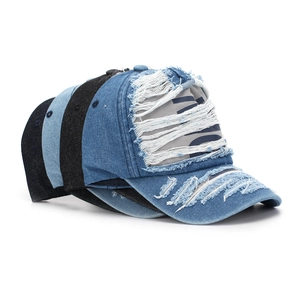 Detail showing distressed denim texture and frayed holes on vintage baseball caps