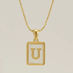 Golden 18K stainless steel square necklace with letter U pendant on beige background