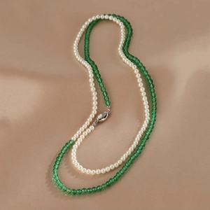 Close-up of elegant double-layer necklace with white pearls and green agate beads