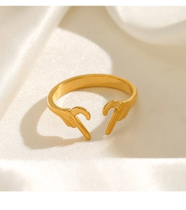 Detail of adjustable gold heart gesture ring resting on soft white silk fabric
