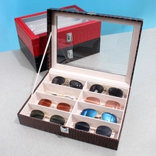 Detailed view of an 8-slot crocodile pattern eyeglass storage box with glass lid