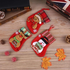 Detailed view of 3D snowman, reindeer and bear Christmas stockings on rustic wood surface
