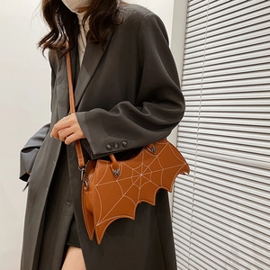 Detail of bat-shaped brown PU leather crossbody bag featuring white spider web stitching