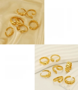 Macro detail of 18K gold plated stainless steel irregular rings on silk and wave stands