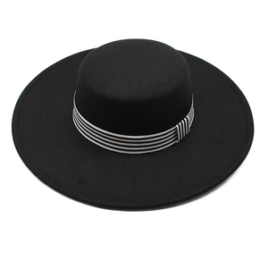 Detail of classic black wool wide-brim fedora with stylish black and white striped band