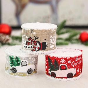 Christmas ribbon rolls with snowman and truck patterns featuring white fuzzy snow edges