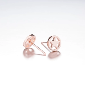 Close-up of rose gold star-shaped hollow hoop earrings with minimalist geometric design