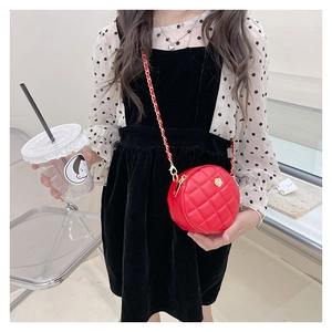 Detail of red quilted round crossbody bag with golden chain strap and flower logo