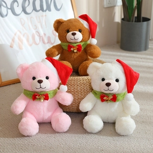 Three Christmas teddy bears in brown, pink, and white wearing red hats and green scarves