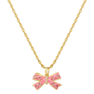 Detail of pink enamel bow pendant with gold wave chain and sparkling zircon stones