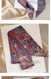 Detail of purple silk scarf with Buddhist oil painting patterns and glossy satin texture