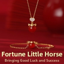 Golden pony necklace and bracelet set with red gemstones and heart zircon details