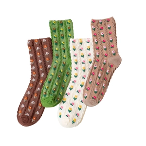 Four pairs of knitted crew socks featuring cute floral patterns in neutral earth tones
