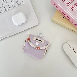 Detail of lavender fabric earphone case with floral bear trim and white snap button