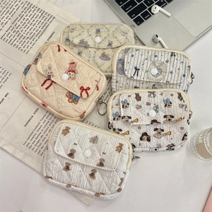 Macro view of five assorted quilted cotton coin purses with floral and cartoon patterns