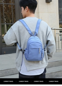 Detail view of the waterproof nylon backpack worn on back, showing practical daily capacity.