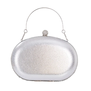 Elegant silver oval evening clutch bag with metallic finish and rhinestone top handle