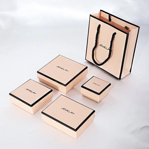 Pink jewelry gift box set with matching paper bag and black trim detail