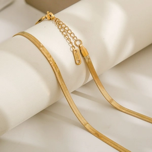 Detail of gold snake bone chain showing the S.STEEL hallmark on the stainless steel clasp