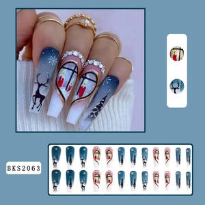 Detailed Christmas press-on nails with blue-white gradient, snowflake art, and rhinestone accents
