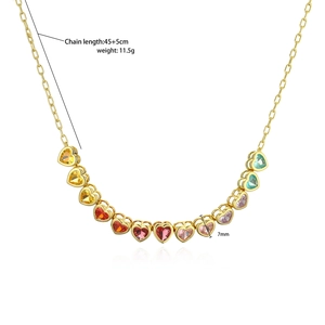 Macro shot of gold necklace featuring colorful rainbow heart-shaped cubic zirconia stones