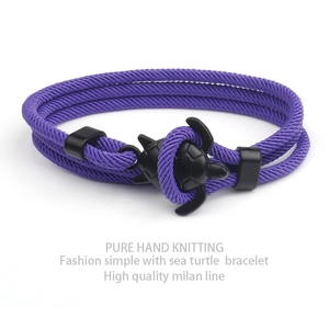 Detail of hand-knitted purple Milan line bracelet with a black sea turtle charm